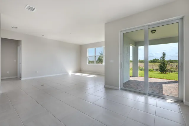 a view of kitchen with kitchen island a sink stainless steel appliances and cabinets