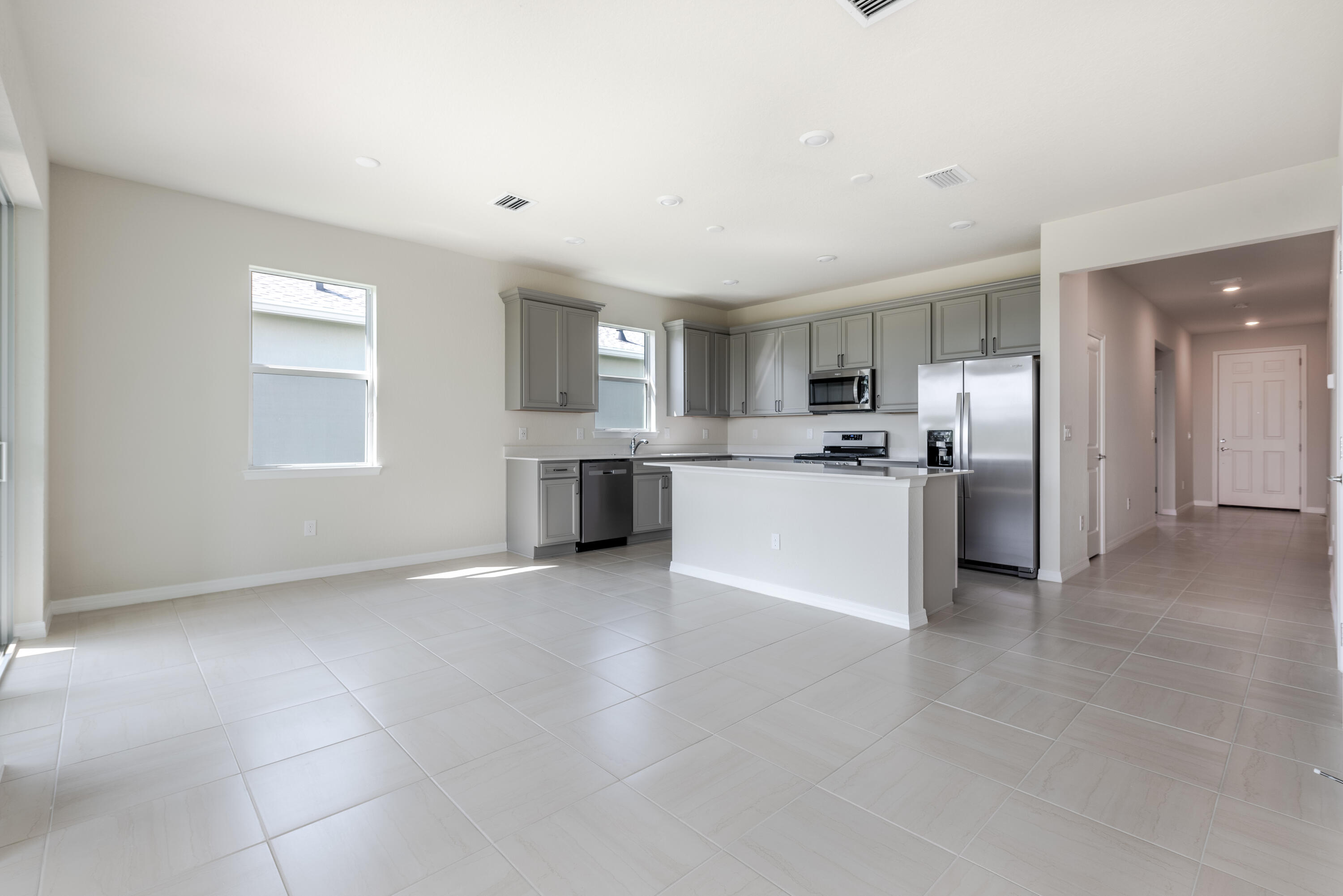 12327 Southwest Sand Dollar Way Port St. Lucie, FL 34987 - Photo 23 of 29 a view of kitchen with kitchen island a sink stainless steel appliances and cabinets