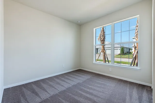a view of an empty room and a window