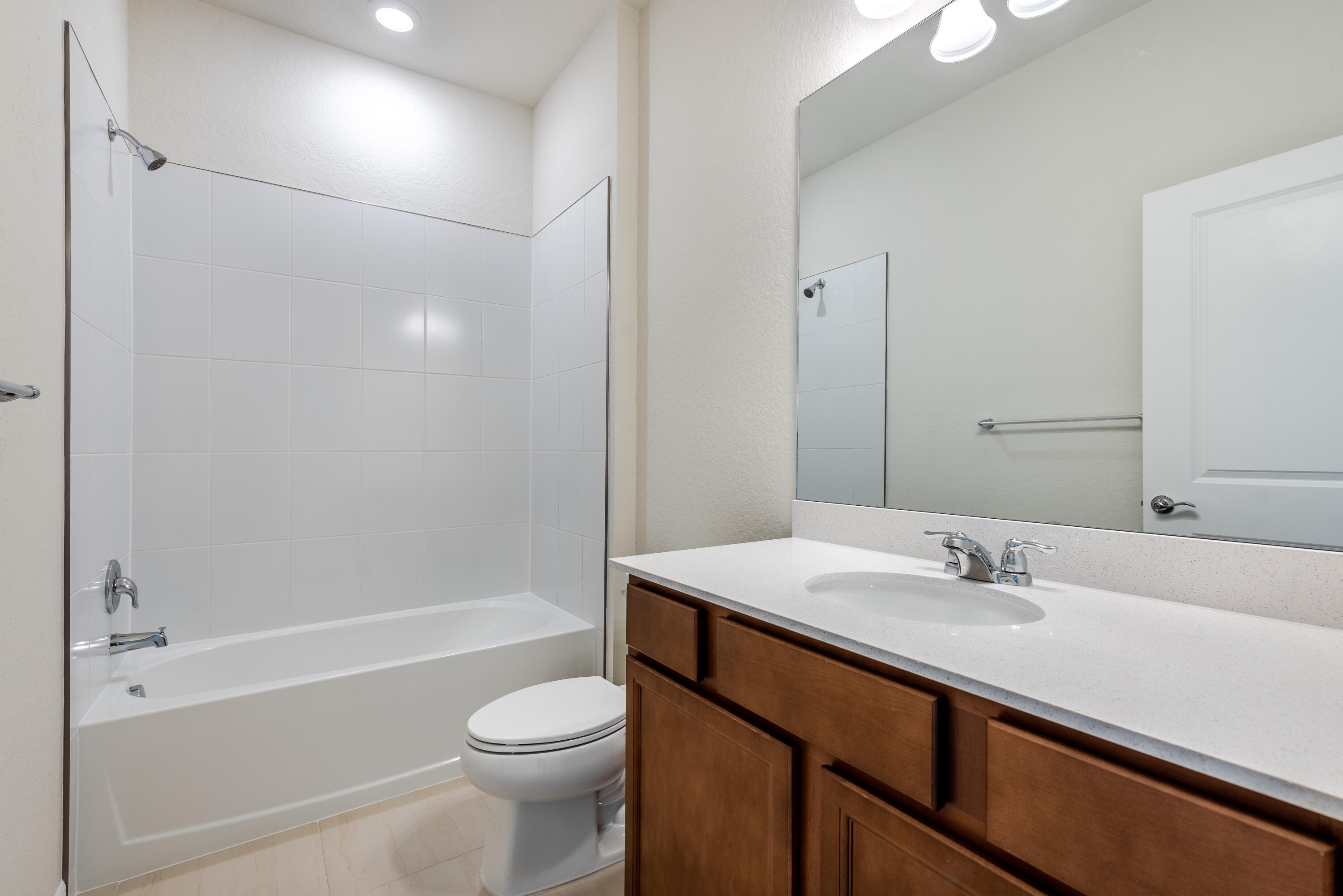 12327 Southwest Sand Dollar Way Port St. Lucie, FL 34987 - Photo 7 of 29 a bathroom with a sink a toilet and shower
