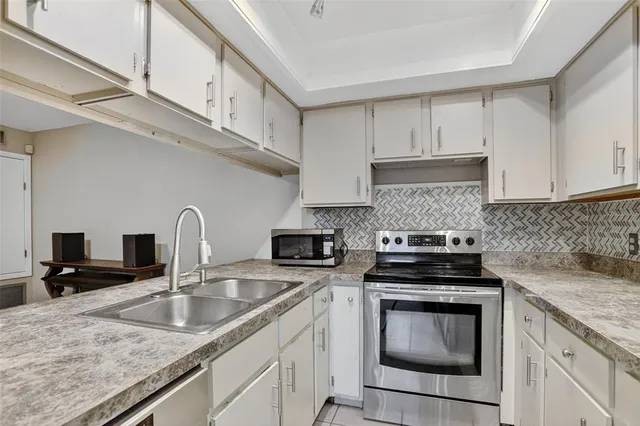 a bathroom with a granite countertop sink mirror vanity and toilet