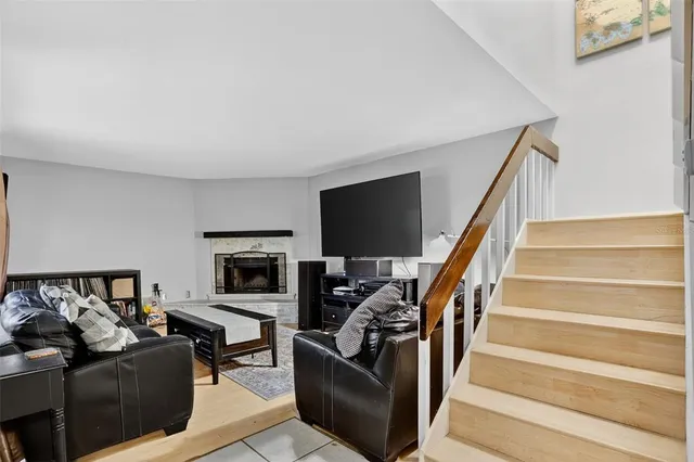 a living room with furniture a flat screen tv and a fireplace