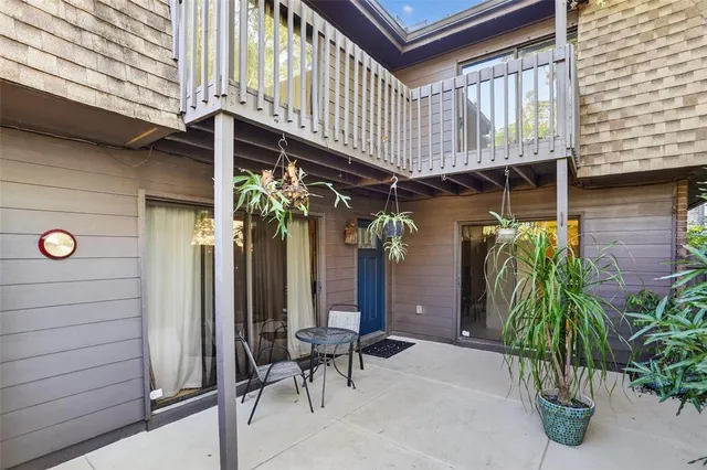 a kitchen with stainless steel appliances granite countertop a stove top oven a sink a dining table and chairs with wooden floor