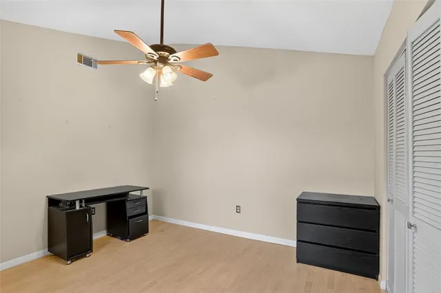 a view of a balcony with wooden floor and fence