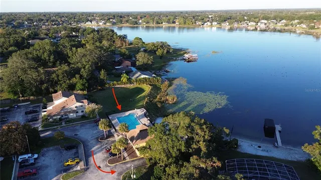 an aerial view of a house with yard and outdoor seating