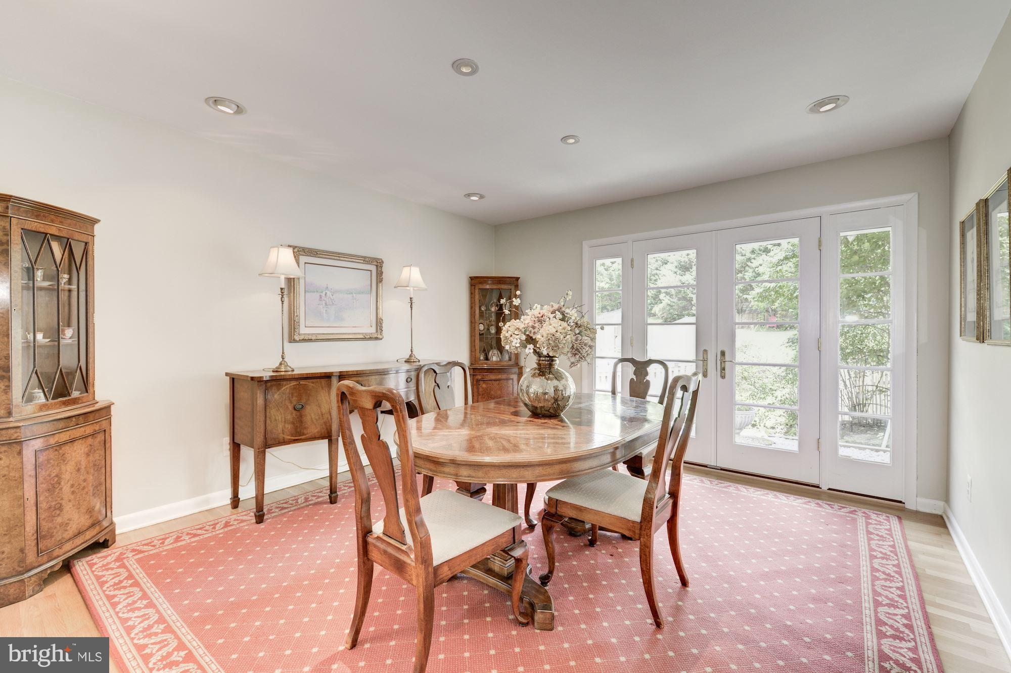 6129 Overlea Road Bethesda, MD 20816 - Photo 16 of 30 a view of a dining room with furniture large windows and wooden floor