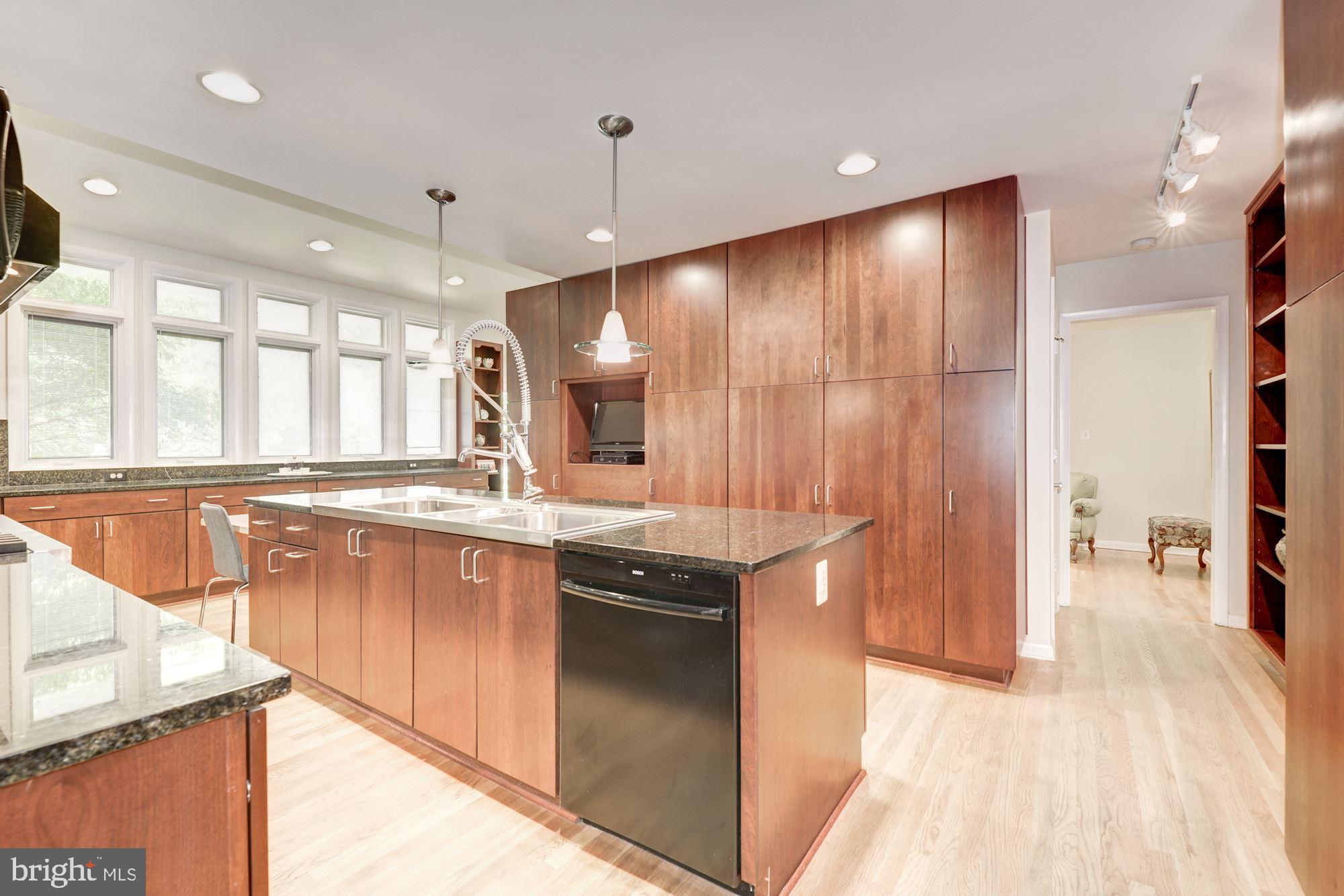6129 Overlea Road Bethesda, MD 20816 - Photo 17 of 30 a large kitchen with granite countertop a sink and dishwasher a stove with wooden floor