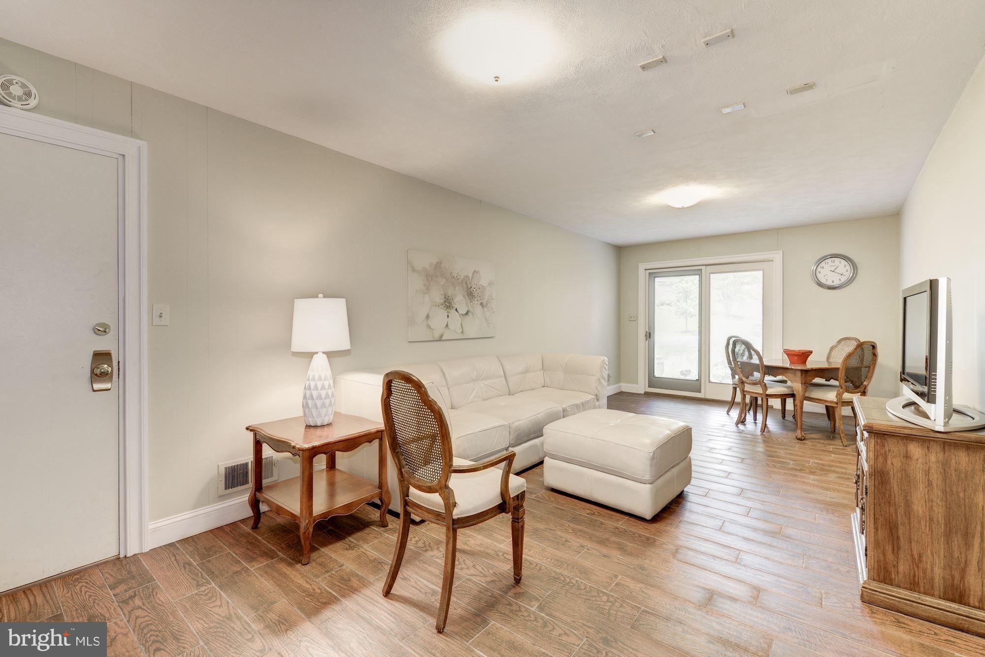 6129 Overlea Road Bethesda, MD 20816 - Photo 4 of 30 a living room with furniture and a wooden floor