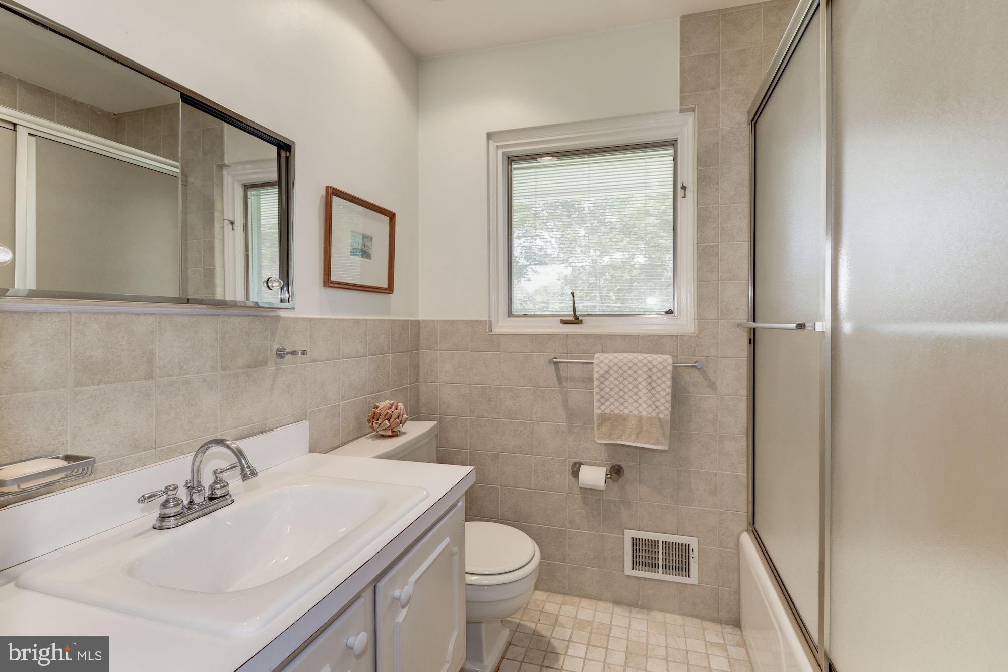 6129 Overlea Road Bethesda, MD 20816 - Photo 7 of 30 a bathroom with a sink toilet and mirror