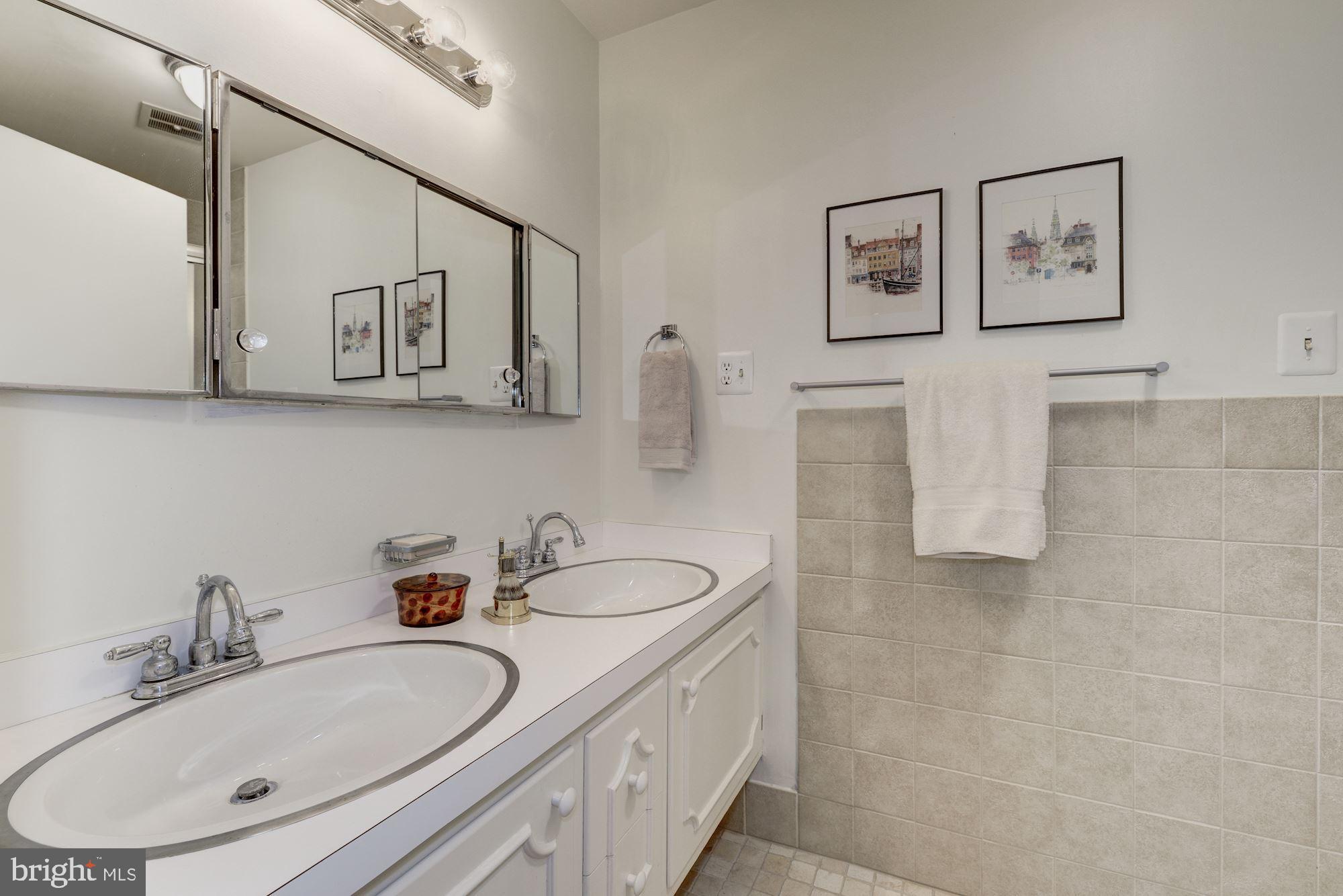 6129 Overlea Road Bethesda, MD 20816 - Photo 9 of 30 a bathroom with a double vanity sink mirror and