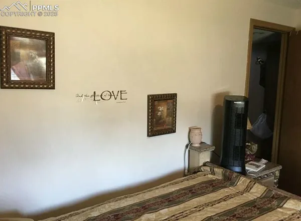 a bedroom with a bed and a painting on the wall