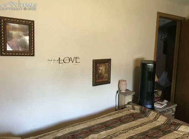 a bedroom with a bed and a painting on the wall