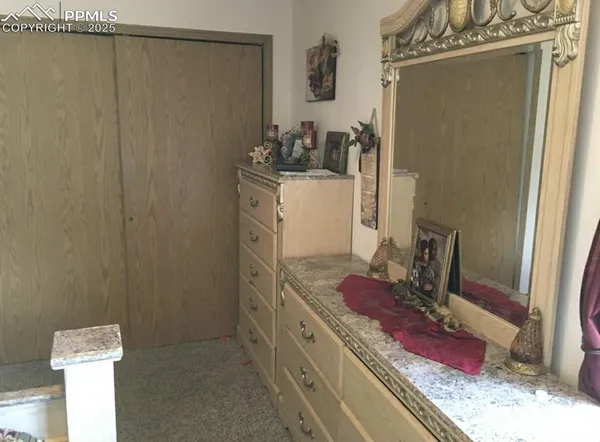 a bathroom with a granite countertop sink a vanity and a shower