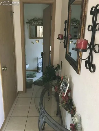 a living room with furniture and a mirror