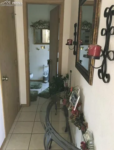 a living room with furniture and a mirror