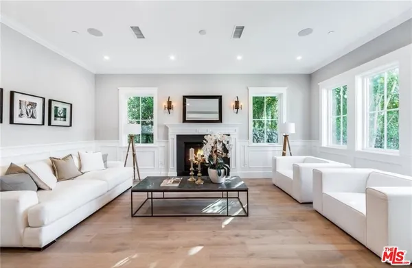 a living room with furniture fireplace and window
