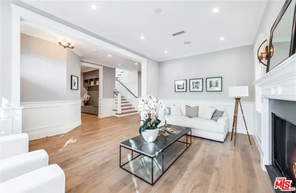 a living room with furniture fireplace and wooden floor