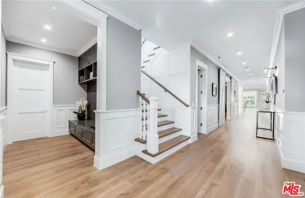 a view of entryway with wooden floor and stairs