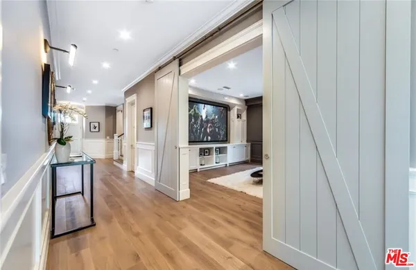 a view of a hallway view with wooden floor and staircase