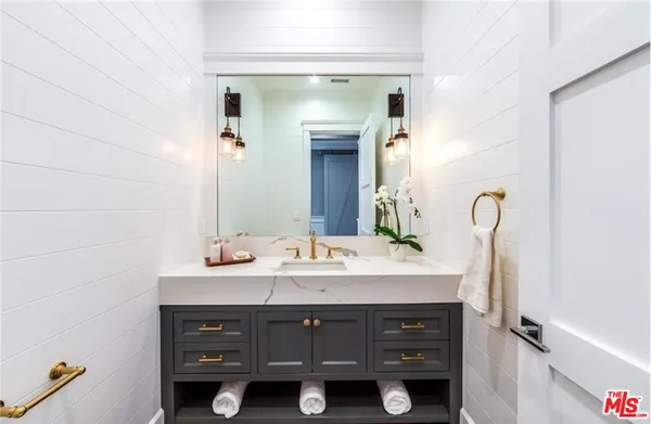 a bathroom with a sink vanity and a mirror