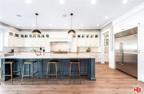 a kitchen with center island table and chairs