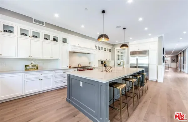 a kitchen with stainless steel appliances kitchen island a large island in the center