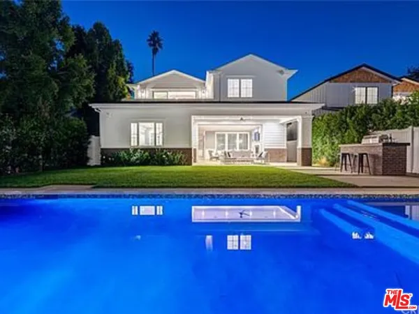 a view of swimming pool with a house in the background