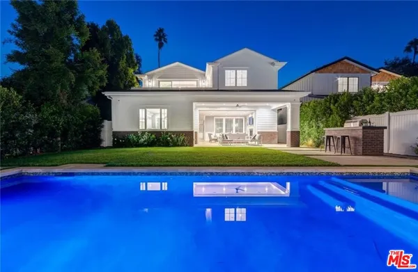 a view of swimming pool with a house in the background