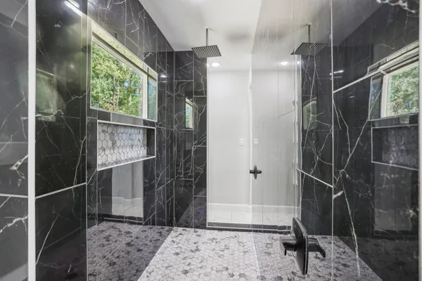 a bathroom with a shower and a sink