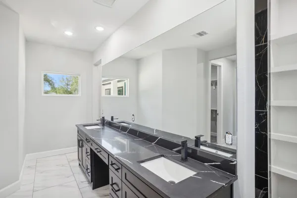 a bathroom with a sink vanity and a mirror