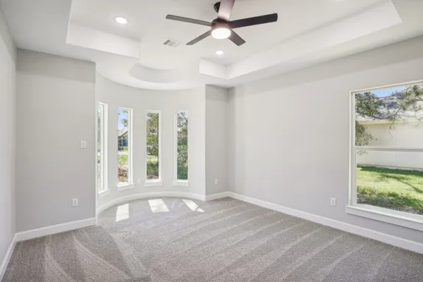 an empty room with windows and closet