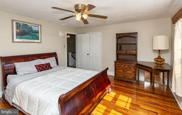a spacious bedroom with a bed and a chandelier