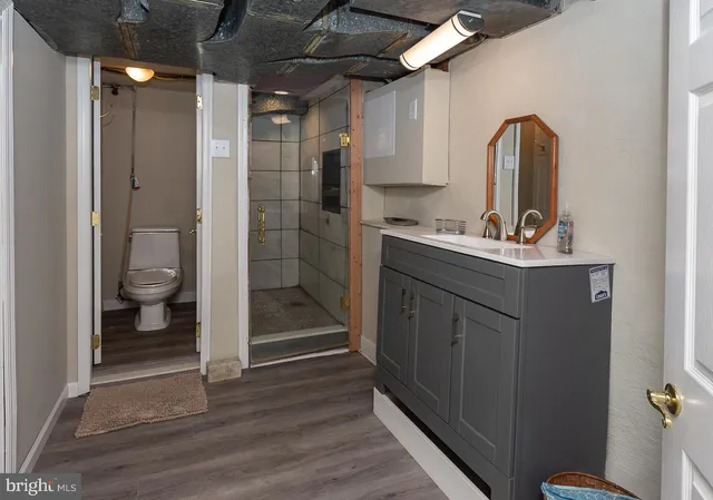 a bathroom with a sink toilet and shower