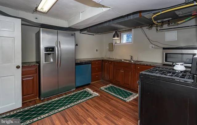 a kitchen with stainless steel appliances granite countertop a refrigerator and a sink