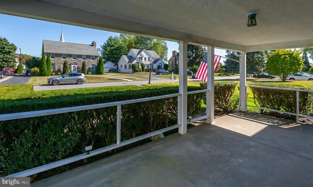 a view of a park with furniture and a porch