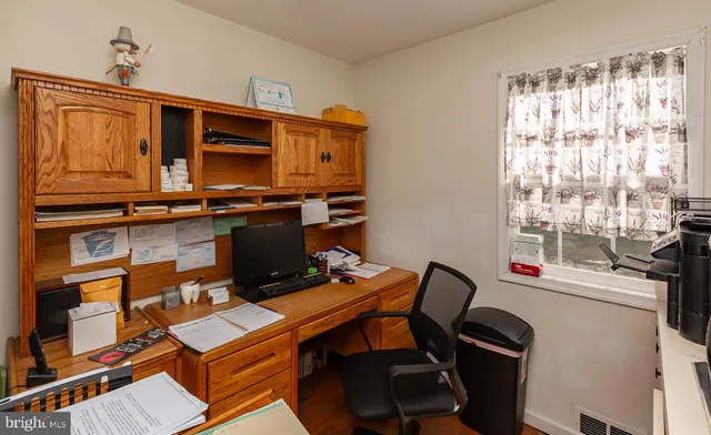 a view of workspace with wooden floor windows