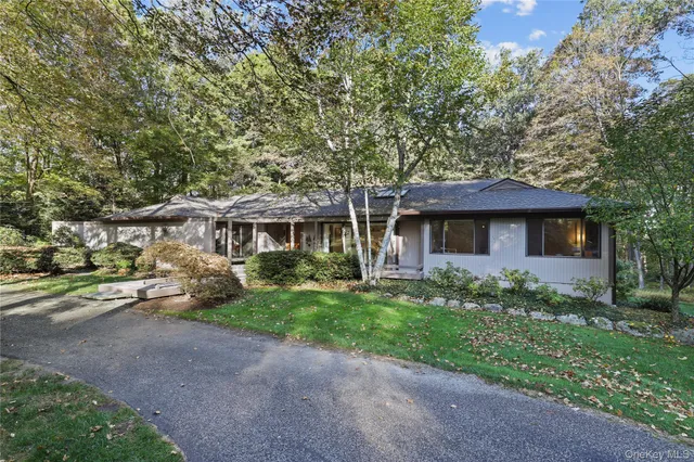 a front view of a house with a garden and yard