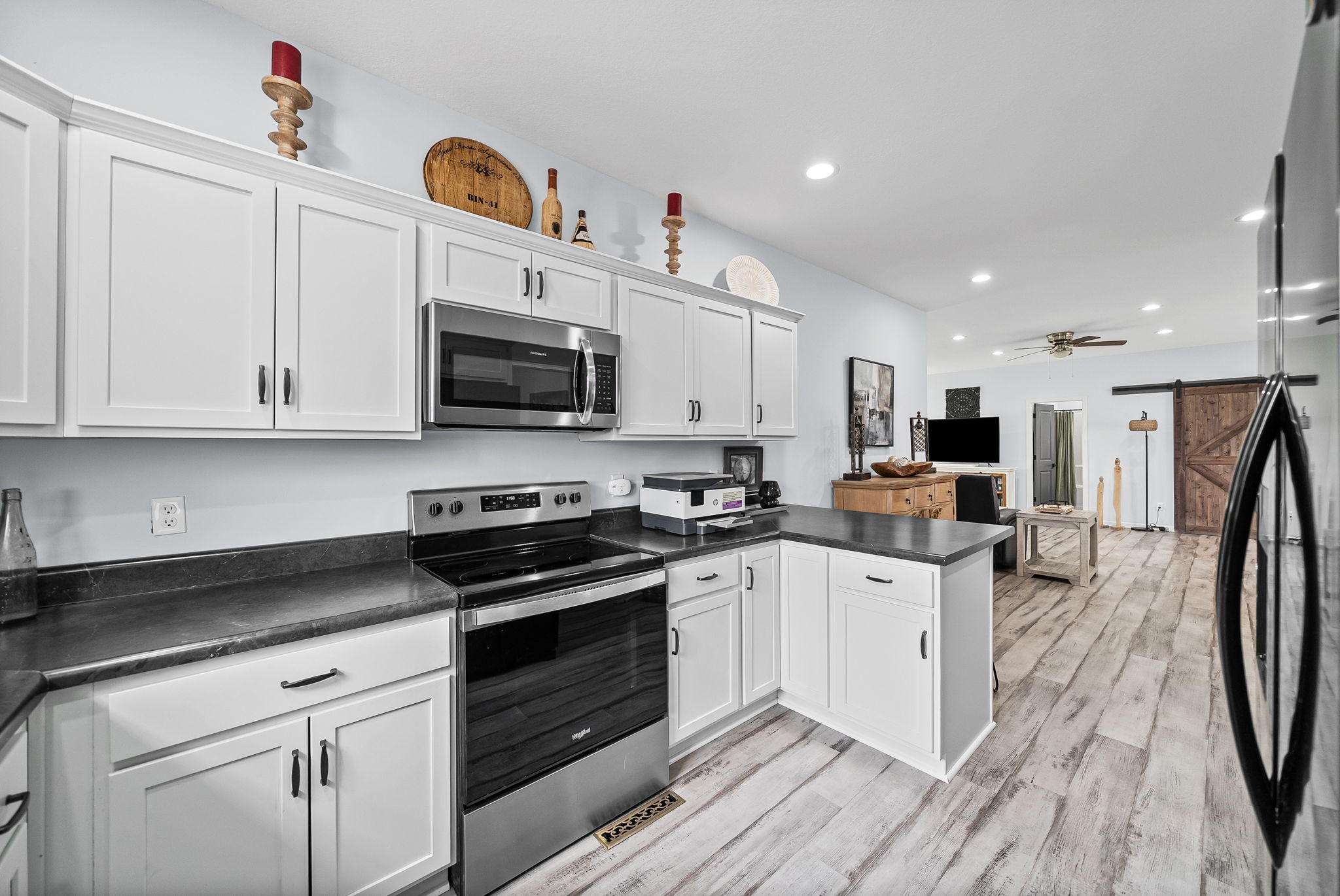 1698 Montgomery Church Road Cadiz, KY 42211 - Photo 15 of 39 a kitchen with granite countertop a sink a stove top oven and cabinetry