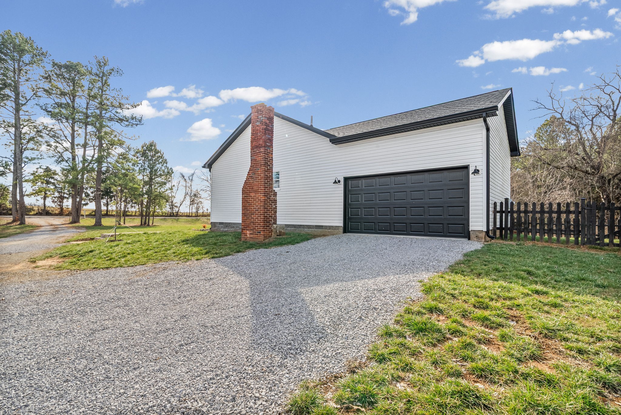 1698 Montgomery Church Road Cadiz, KY 42211 - Photo 29 of 39 a front view of a house with a yard and garage