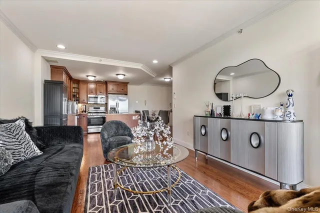 a living room with furniture and kitchen view
