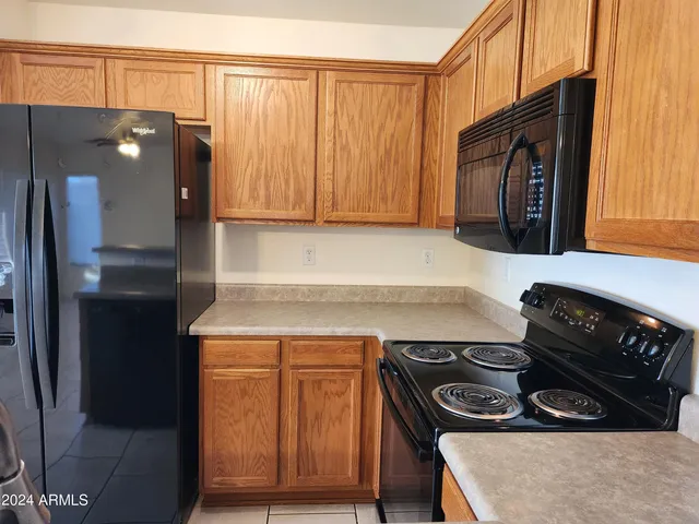 a kitchen with a stove and a refrigerator