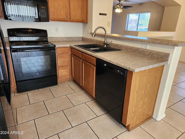 a kitchen with a sink a stove and a microwave oven in a cabinets