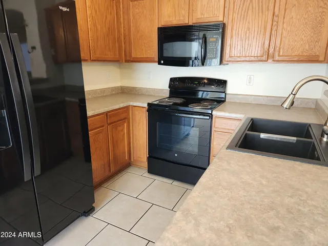 a kitchen with a sink and a stove top oven