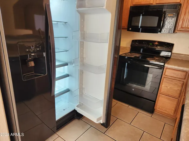 a kitchen with a refrigerator and an oven
