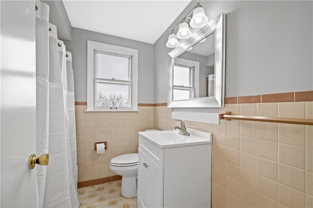 29 Carleton Drive Pittsburgh, PA 15243 - Photo 17 of 25 a bathroom with a toilet a sink a mirror a window and vanity