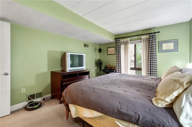 a bedroom with a bed and a television