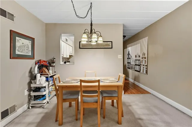a view of a dining room with furniture wooden floor and a chandelier