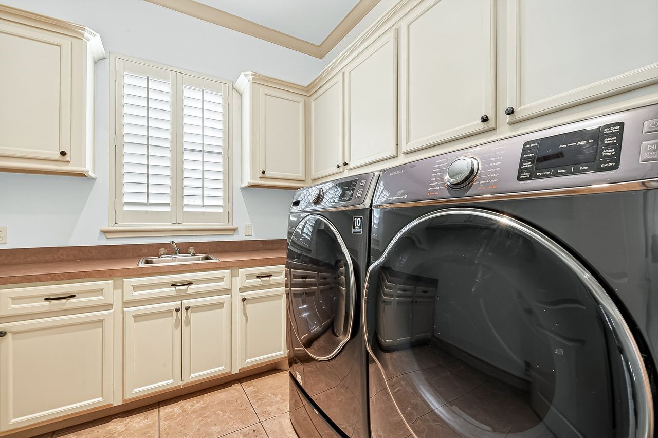 16610 Champagne Falls Court Spring, TX 77379 - Photo 34 of 50 Laundry room with ample cabinetry, sink & plantation shutters