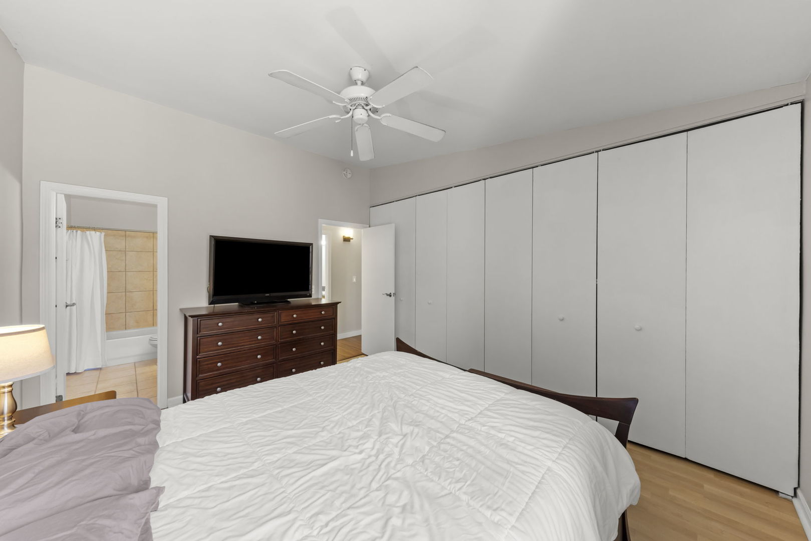 6010 Forest View Road, Unit 3A Lisle, IL 60532 - Photo 12 of 20 a bedroom with a bed and a flat screen tv