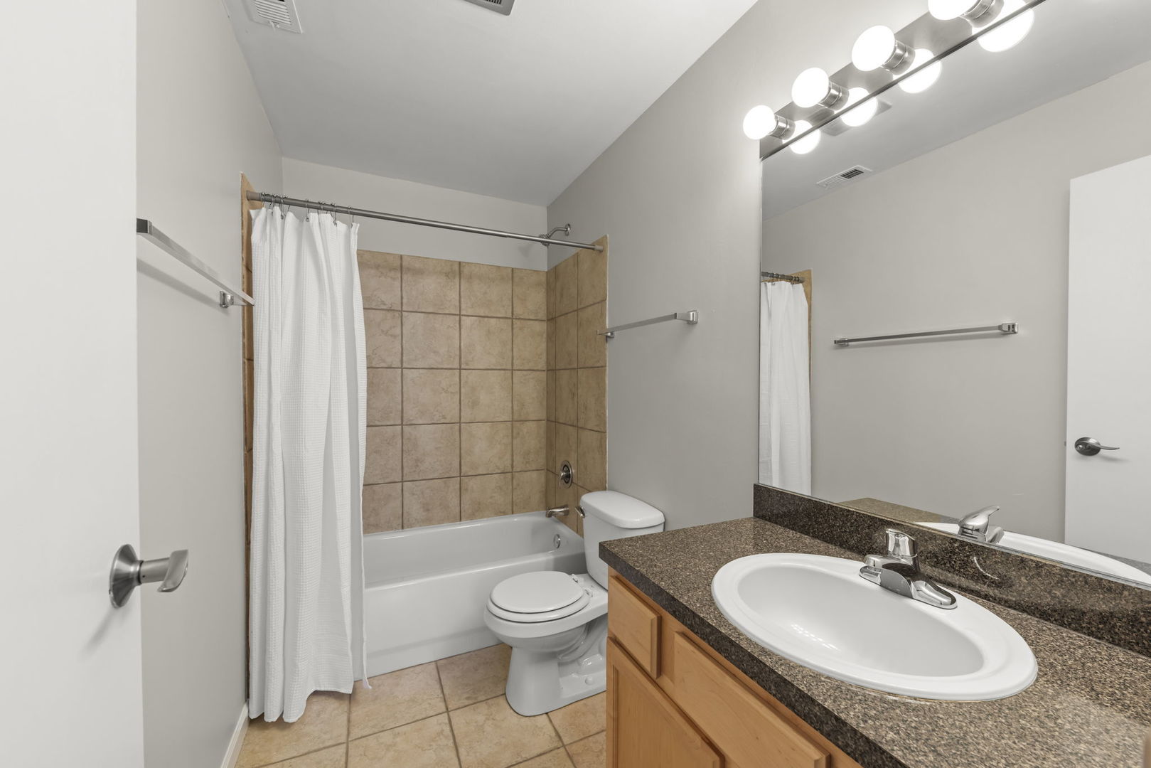 6010 Forest View Road, Unit 3A Lisle, IL 60532 - Photo 14 of 20 a bathroom with a granite countertop sink toilet a mirror and shower
